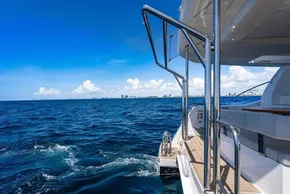 2025 Leopard 40 Powercat cruising on open sea under clear blue sky.