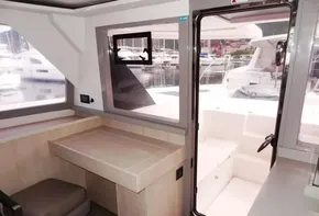 Interior of a 2017 Leopard 45 catamaran with desk and seating area.