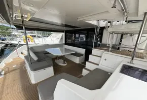 Spacious deck area on a 2019 Leopard 45 catamaran with seating and table.