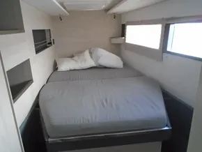 Cozy bedroom in a 2017 Leopard 45 catamaran with modern furnishings.