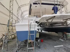 2015 Leopard 51 Powercat undergoing maintenance in a covered boatyard.