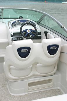 Crownline Cruiser 250 CR - Double bucket seat facing helm controls. Seat back inserts are color-matched to the dash and steering wheel inserts