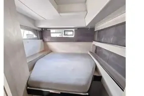 Compact cabin interior of 2019 Leopard 50 yacht with bed and window.