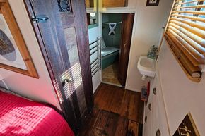 Interior of a 1927 Classic Dutch Barge with wooden floors and cozy cabin space.