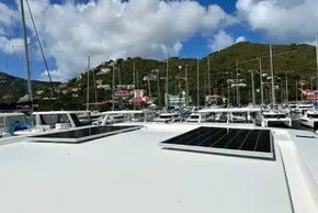 2025 Robertson and Caine Leopard 46 Powercat with solar panels, docked in a scenic marina.