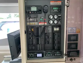 Electrical control panel on a 2021 Leopard 45 yacht, featuring gauges and communication devices.