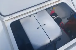 Open storage compartment on 2024 Lagoon 42 catamaran, showing equipment and wiring.