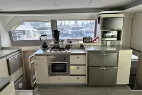 Modern kitchen interior on a 2021 Leopard 50 yacht, featuring appliances and marina view.