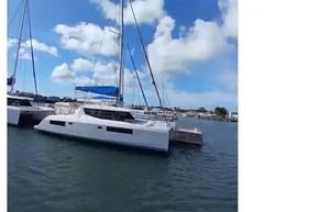 2018 Leopard 45 catamaran docked in a marina under a clear blue sky.