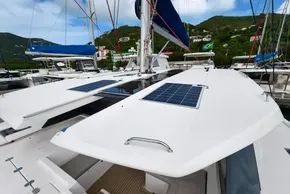 2019 Leopard 50 catamaran with solar panels docked in a scenic marina.
