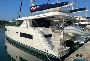 2021 Leopard 45 catamaran docked at marina, featuring sleek design and spacious deck.