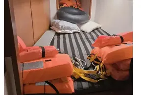 Cabin interior of 2008 Leopard 38 yacht with life jackets and striped bedding.