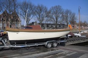 Enkhuizensloep 780 boat on trailer, docked in a scenic harbor, 2026 model.