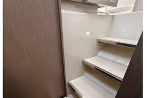 Modern interior stairs in 2021 Leopard 50 yacht, featuring sleek wood and metal design.