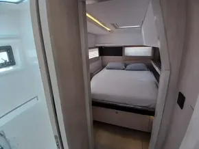 Interior cabin of 2019 Leopard 45 yacht with cozy bed and modern design.
