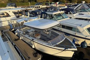 2015 Alfastreet 23 boat docked among other vessels at a marina.