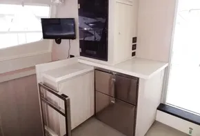 Interior of 2015 Leopard 51 Powercat with modern kitchen and small TV.