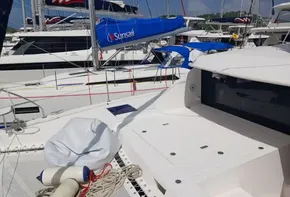 Leopard 40 catamaran, 2021 model, docked with other sailboats, featuring deck and ropes.