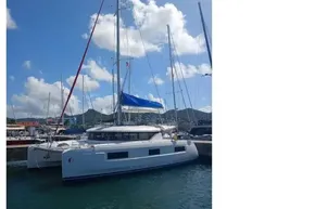 2020 Lagoon 46 catamaran docked under a clear blue sky.