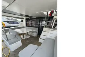 Spacious interior of 2019 Leopard 50 yacht with modern seating and dining area.