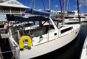 2017 Beneteau Oceanis 38 sailboat docked at marina under blue sky.