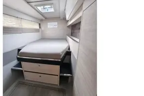 Compact bedroom interior of 2019 Leopard 50 yacht with modern design and storage drawers.