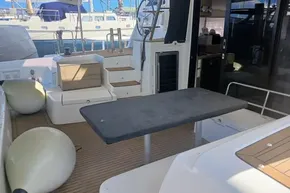 2024 Lagoon 42 yacht deck with seating, table, and nautical equipment.