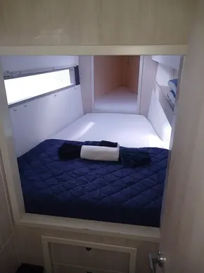 Cozy cabin interior of 2021 Leopard 40 catamaran with neatly arranged bedding.