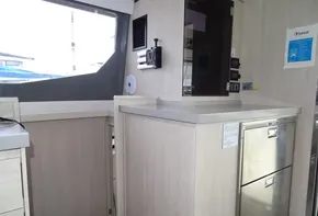Modern kitchen area in 2017 Leopard 45 yacht with light wood cabinetry.