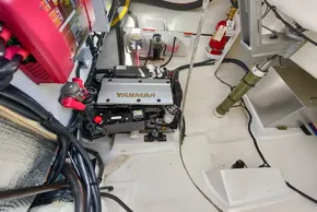 Engine room of 2021 Leopard 50 yacht featuring Yanmar engine and safety equipment.