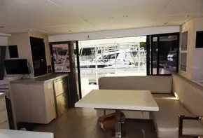 Interior of 2017 Leopard 43 Powercat yacht with dining area and marina view.