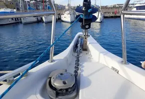 Jeanneau Sun Odyssey 440 sailboat deck with anchor chain, docked in marina, 2019 model.