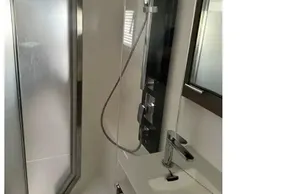Modern bathroom in 2022 Leopard 53 Powercat yacht with sleek shower and sink.