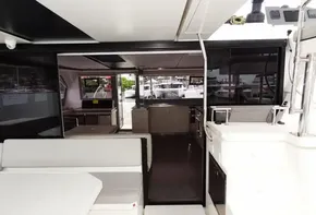 Interior view of 2020 Leopard 50 yacht with modern seating and kitchen area.