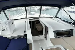 2023 Beneteau Oceanis 51.1 yacht cockpit with seating and open cabin entrance.