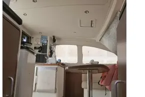 Interior of 2008 Leopard 38 catamaran, featuring a compact dining area and cabinetry.