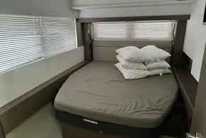 Interior cabin of 2022 Leopard 53 Powercat with bed and pillows.