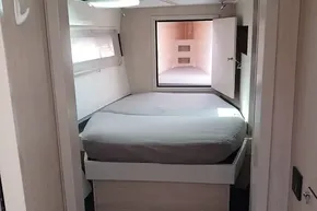 Luxurious bedroom interior of 2017 Leopard 48 yacht with modern design and cozy bed.
