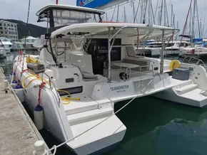 2020 Lagoon 42 catamaran docked at marina, featuring spacious deck and modern design.