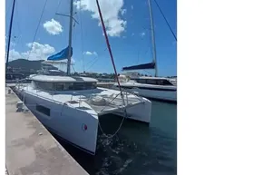 2020 Lagoon 46 catamaran docked under clear blue sky.