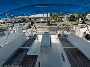 Cockpit of 2019 Jeanneau Sun Odyssey 440 sailboat with dual steering wheels and blue canopy.