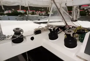 Leopard 50 yacht deck with winches and colorful coastal buildings in the background.