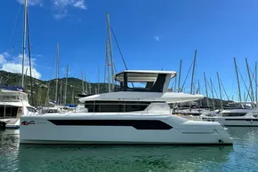 2022 Leopard 53 Powercat yacht docked in a marina under clear blue skies.