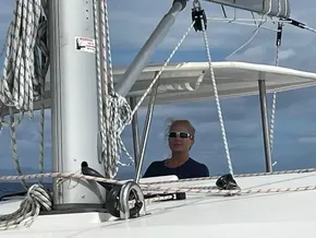 Person sailing a 2020 Leopard 40 catamaran on a sunny day.
