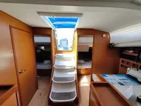 Interior of 2019 Jeanneau Sun Odyssey 440 sailboat, featuring wooden finishes and cozy cabins.