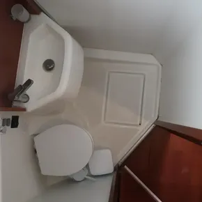 Bathroom interior of 2018 Beneteau Oceanis 51.1 yacht, featuring sink and toilet.
