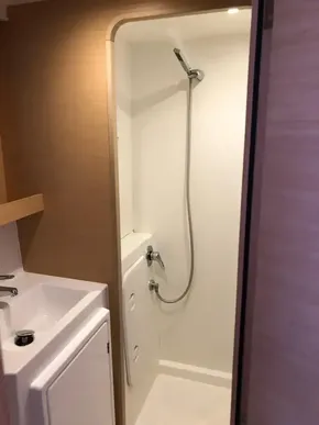 Modern bathroom in 2020 Lagoon 42 catamaran with shower and sink.