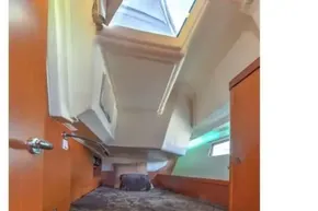 Cozy cabin interior of 2013 Beneteau Oceanis 41 sailboat with skylight and wooden finish.