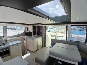 Luxurious interior of 2019 Leopard 45 catamaran with modern kitchen and seating area.