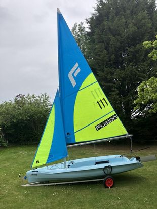 Fusion sailing dinghy with trolley and cover with option for road base